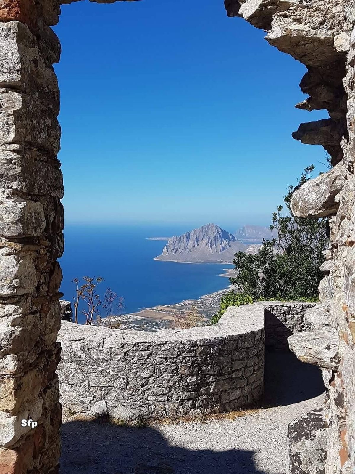 View of Monte Cofano and the coast through the stone ruins