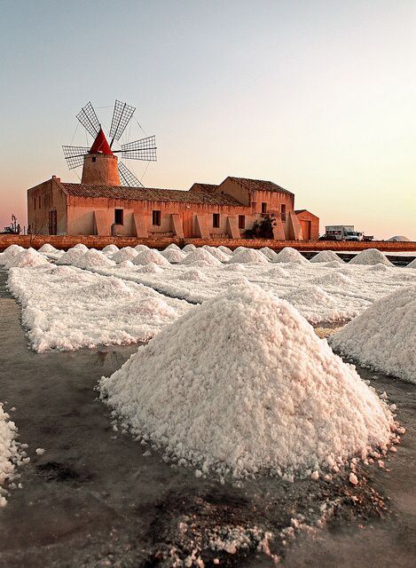 Salt mounds and a windmill at the Trapani salt pans